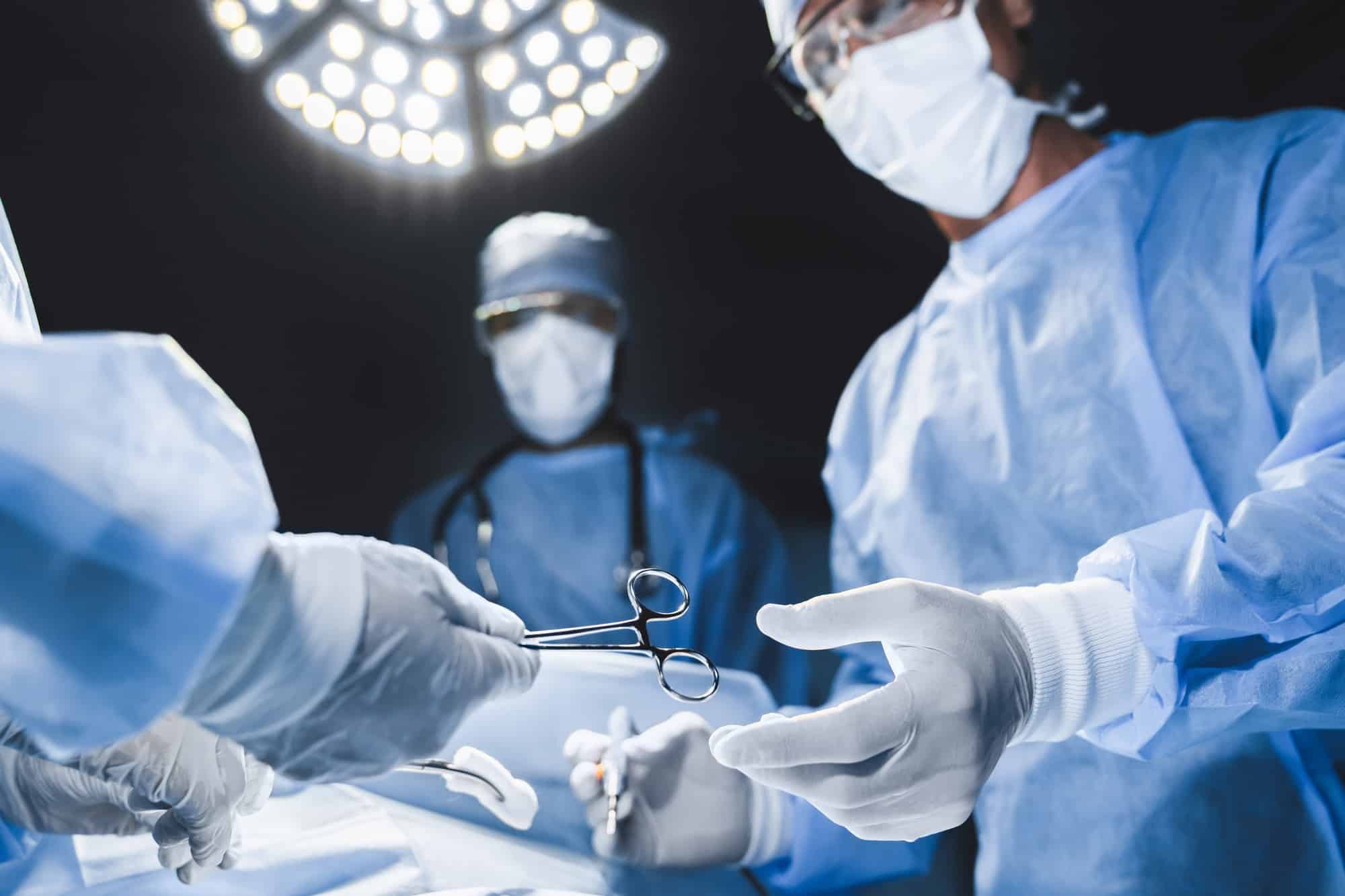 Close up of surgery team operating in moern hospital.