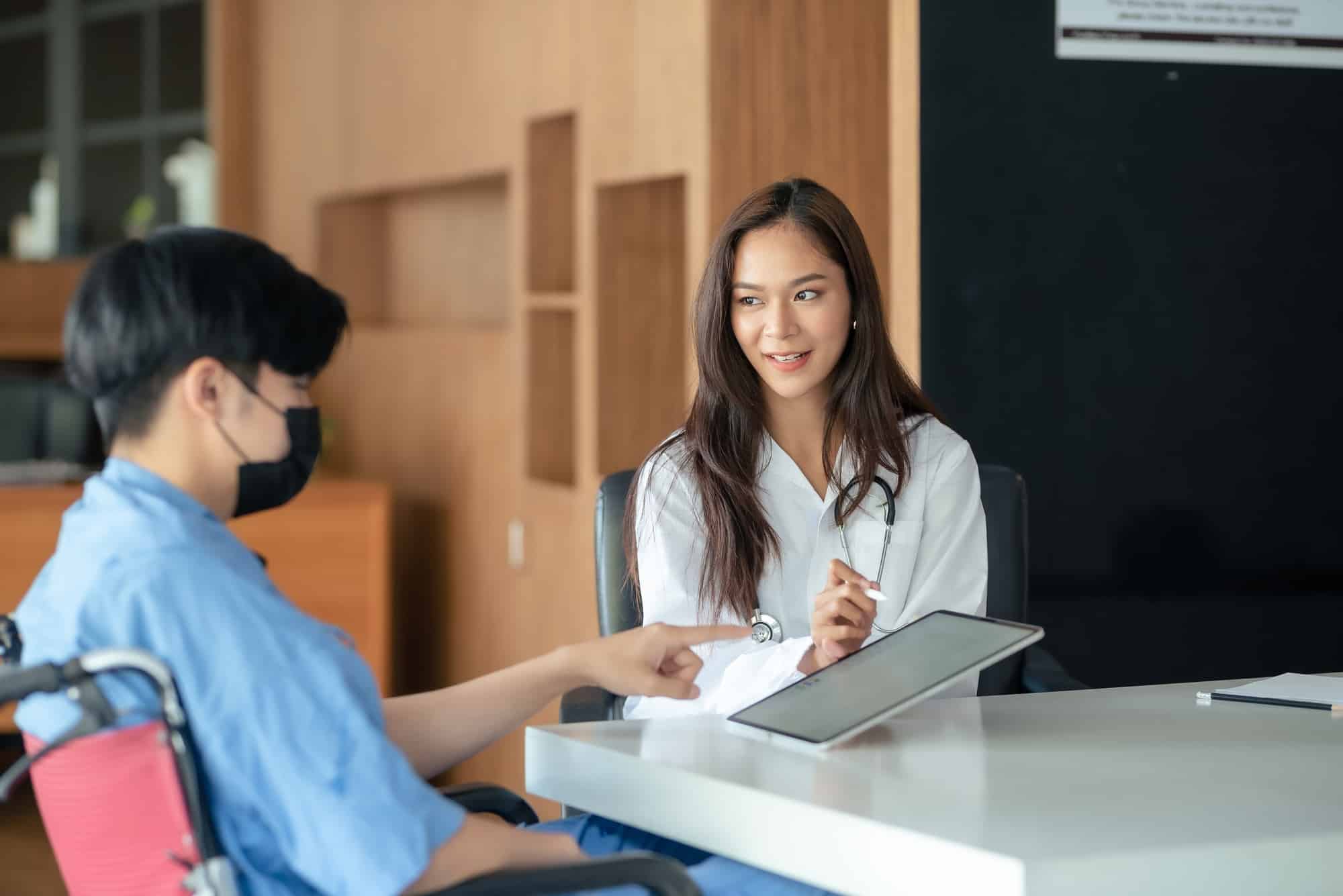 Healthcare professional consulting with a patient in a medical office.