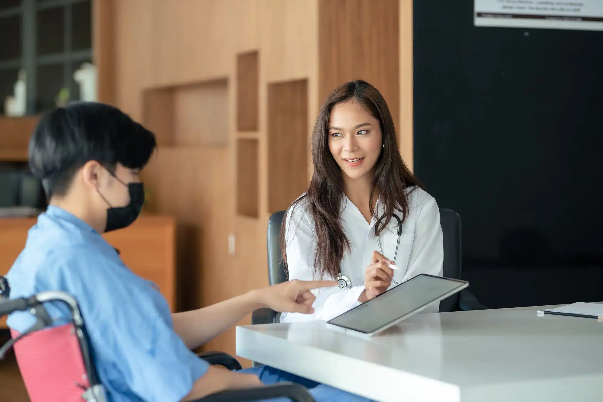 Healthcare professional consulting with a patient in a medical office.
